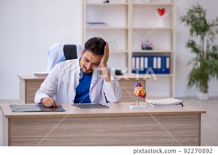 Young male doctor working in the clinic Young male doctor working in the clinic 92270892