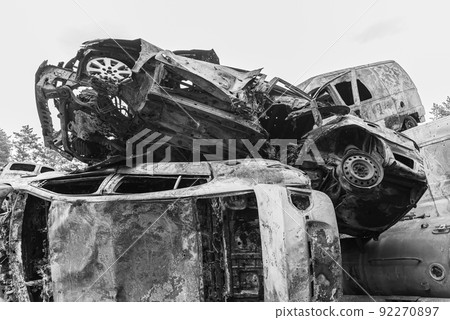 Shot and burned cars during the war in Ukraine, black and white photo 92270897
