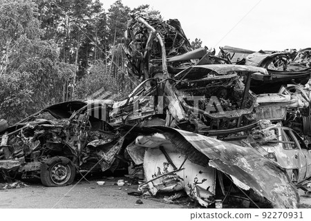 Shot and burned cars during the war in Ukraine, black and white photo 92270931