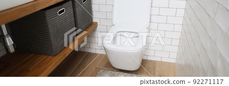 Modern bathroom interior with wooden shelves, white sink and toilet Modern bathroom interior with wooden shelves, white sink and toilet 92271117