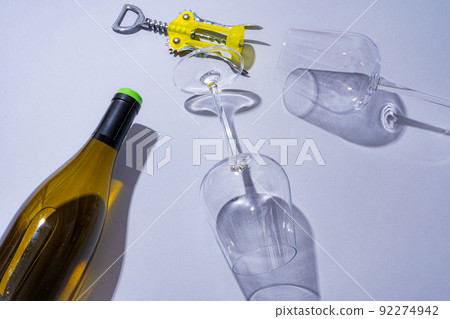 Wine bottle and glass on gray background flat lay Wine bottle and glass on gray background flat lay 92274942