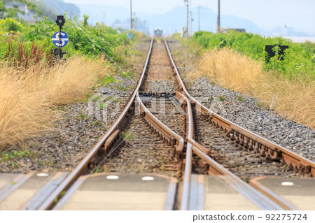 Local train coming over a small hill 92275724