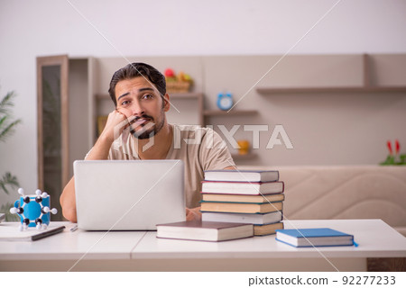 Young male student studying at home during pandemic Young male student studying at home during pandemic 92277233
