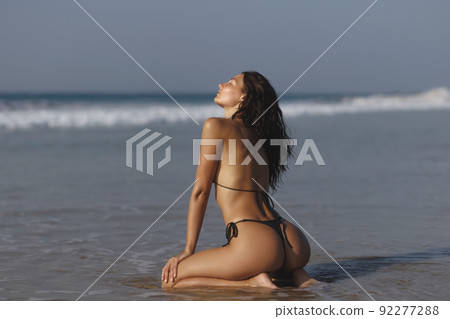 Summer is the perfect time to be sexy. Fashion shot of a gorgeous young woman on the beach. Summer is the perfect time to be sexy. Fashion shot of a gorgeous young woman on the beach. 92277288