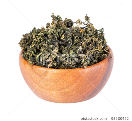 Dry gynostemma pentaphyllum leaf in wooden bowl, isolated on white blackground. Jiaogulan or Miracle grass. Chinese herbal tea. Dry gynostemma pentaphyllum leaf in wooden bowl, isolated on white blackground. Jiaogulan or Miracle grass. Chinese herbal tea. 92280422