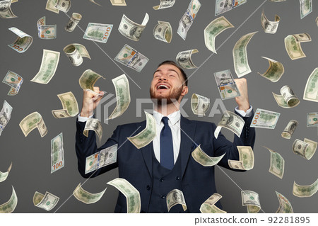 Rain of us dollar money and happy excited businessman on grey background 92281895