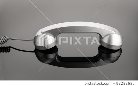 Retro telephone handset on dark background. Contact us concept Retro telephone handset on dark background. Contact us concept 92282683