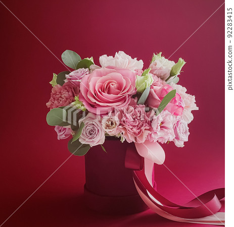 Beautiful flower box on red background, bouquet of blooming flowers as holiday gift, luxury floral design concept 92283415