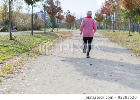 Rear View Of Senior Man Running Against Sky At Park Rear View Of Senior Man Running Against Sky At Park 92283520
