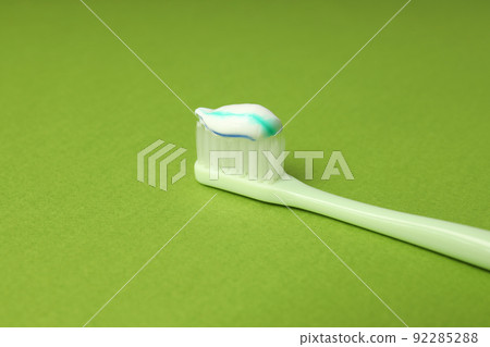 Concept of tooth care on green background 92285288