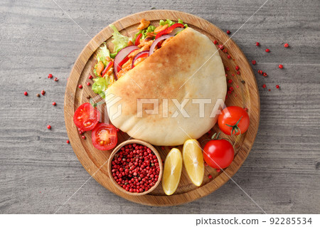 Concept of tasty food with pita with chicken meat Concept of tasty food with pita with chicken meat 92285534