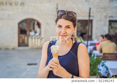 Woman tourist enjoying Colorful street in Old town of Kotor on a sunny day, Montenegro. Travel to Montenegro concept Portrait of a disgruntled girl sitting at a cafe table Woman tourist enjoying Colorful street in Old town of Kotor on a sunny day, Montenegro. Travel to Montenegro concept Portrait of a disgruntled girl sitting at a cafe table 92286243