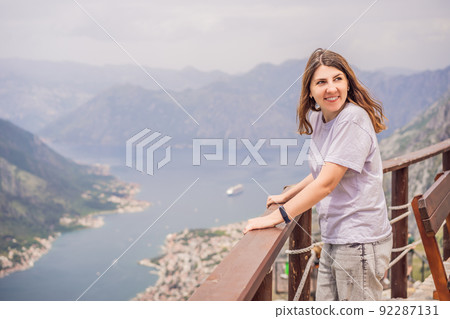 Woman tourist enjoys the view of Kotor. Montenegro. Bay of Kotor, Gulf of Kotor, Boka Kotorska and walled old city. Travel to Montenegro concept. Fortifications of Kotor is on UNESCO World Heritage Woman tourist enjoys the view of Kotor. Montenegro. Bay of Kotor, Gulf of Kotor, Boka Kotorska and walled old city. Travel to Montenegro concept. Fortifications of Kotor is on UNESCO World Heritage 92287131