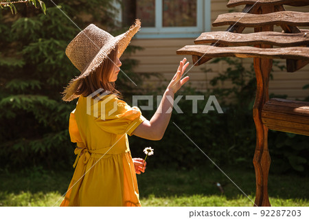 cute little girl in a yellow dress and straw hat cute little girl in a yellow dress and straw hat 92287203