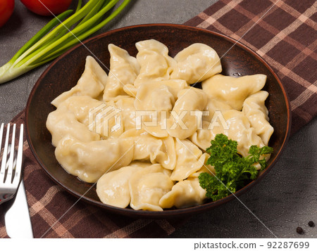 dumplings with chicken on a clay plate decorated with herbs 92287699