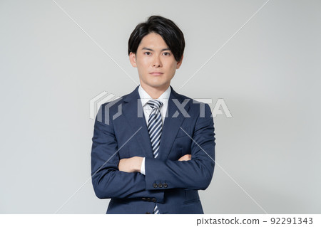 Portrait of a young businessman with arms folded on a white background 92291343