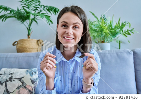 Webcam view of young talking female in home office 92291416