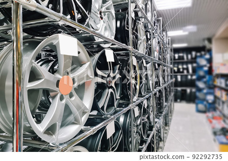 Auto shop selling car rims. Stand for sale of alloy wheels. Discounts at auto parts store. Auto shop selling car rims. Stand for sale of alloy wheels. Discounts at auto parts store. 92292735
