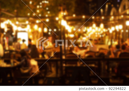 blurred image at the restaurant night time, many people in the restaurant eat and party happy relaxing 92294822