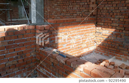 SELANGOR, MALAYSIA -MARCH 5, 2022: Brick installation works at construction sites. Bricks are installed in layers and joined with cement mortar. 92295490