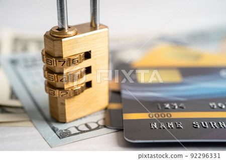 Credit card with password key lock security on US dollar background. Credit card with password key lock security on US dollar background. 92296331