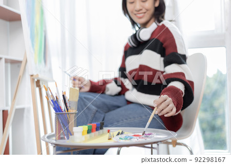 Female artist painting on canvas, Artist studio interior, Draw with watercolor, Drawing supplies , Painting and creativity, Use a brush to draw a pattern by stripes, Artwork, Using Paint Brush. Female artist painting on canvas, Artist studio interior, Draw with watercolor, Drawing supplies , Painting and creativity, Use a brush to draw a pattern by stripes, Artwork, Using Paint Brush. 92298167
