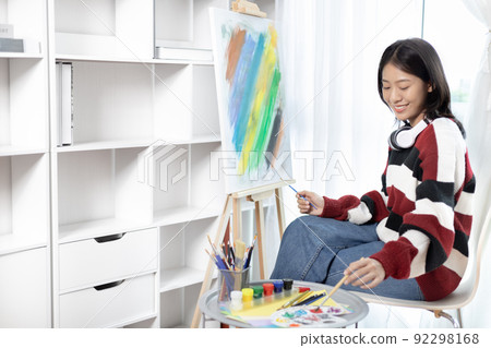 Female artist painting on canvas, Artist studio interior, Draw with watercolor, Drawing supplies , Painting and creativity, Use a brush to draw a pattern by stripes, Artwork, Using Paint Brush. 92298168