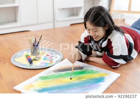 Female artist painting on canvas, Artist studio interior, Draw with watercolor, Drawing supplies , Painting and creativity, Use a brush to draw a pattern by stripes, Artwork, Using Paint Brush. 92298237