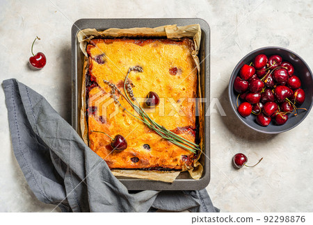 Fresh baked sweet cherry pie or red brownie cake in baking sheet with lavender, napkin and raw berries aside. 92298876