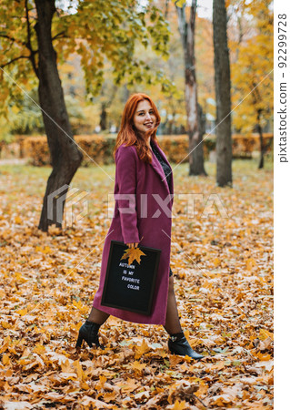 Hello autumn. Red hair girl with Letter message board with text Autumn is my favorite color 92299728