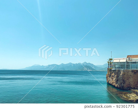 clear, blue water of the sea. a yacht with tourists floats on the water. next to the sea are high mountains. rest in a hot country by the water. swimming in the sea clear, blue water of the sea. a yacht with tourists floats on the water. next to the sea are high mountains. rest in a hot country by the water. swimming in the sea 92301775