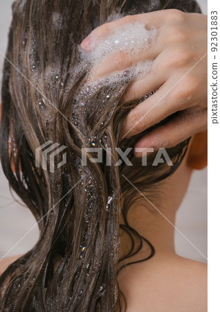 Closeup of the female washing her hair Closeup of the female washing her hair 92301883