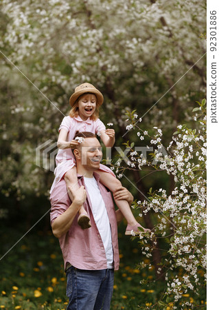 Father and little daughter are walking. Father and little daughter are walking. 92301886