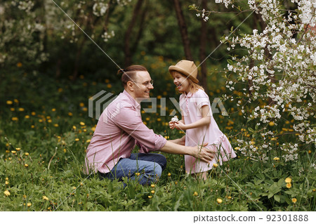 Father and little daughter are walking. Father and little daughter are walking. 92301888