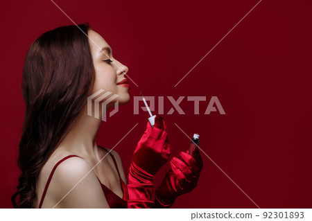 Beautiful young woman in red Beautiful young woman in red 92301893