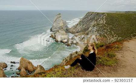 Sitting at the coast of Cabo da Roca in Portugal 92303157