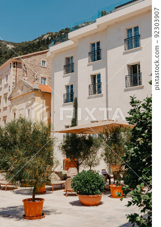 Historic city of Perast at Bay of Kotor in summer, Montenegro. Scenic panorama view of the historic town of Perast at famous Bay of Kotor with blooming flowers on a beautiful sunny day with blue sky 92303907