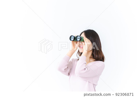 用雙筒望遠鏡看遠方的年輕女子 92306871