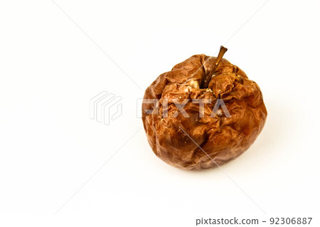 Old rotten apple with large DOF on white background 92306887