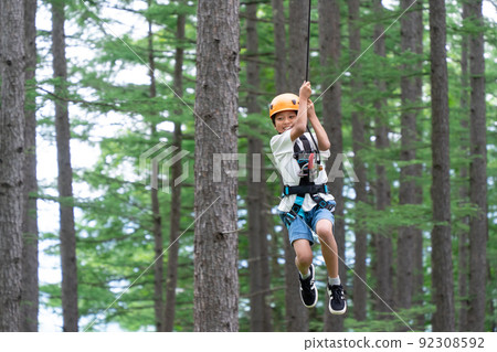 Asian elementary school students playing zipline during summer vacation 92308592