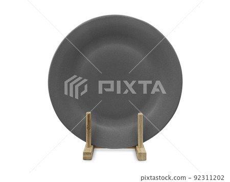 Ceramic plates in wooden stand, isolated on white Ceramic plates in wooden stand, isolated on white 92311202