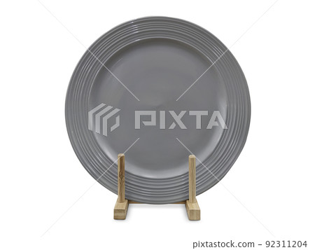 Ceramic plates in wooden stand, isolated on white Ceramic plates in wooden stand, isolated on white 92311204