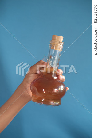 holding a apple vinegar glass bottle holding a apple vinegar glass bottle 92313770