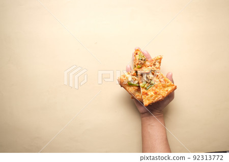 holding cheese pizza on blue background holding cheese pizza on blue background 92313772