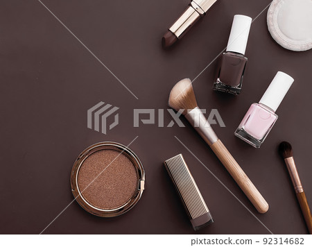 Beauty, make-up and cosmetics flatlay design with copyspace, cosmetic products and makeup tools on brown background, girly and feminine style concept Beauty, make-up and cosmetics flatlay design with copyspace, cosmetic products and makeup tools on brown background, girly and feminine style concept 92314682