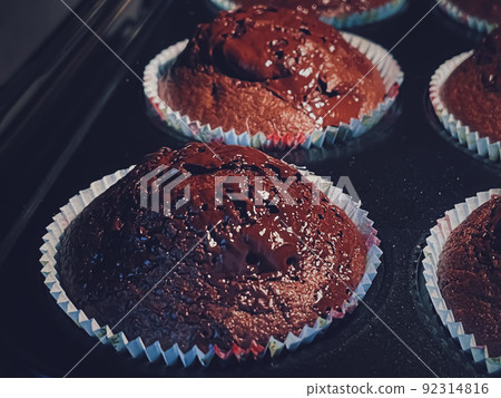 Chocolate muffins baking in the oven, homemade cakes recipe, food and cooking concept Chocolate muffins baking in the oven, homemade cakes recipe, food and cooking concept 92314816