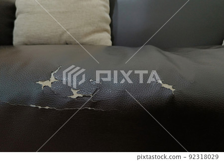 torn old leather black sofa. old leather seat lack from long service life 92318029
