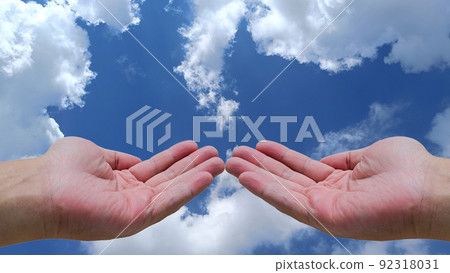 Two open hands of young Asian man sky and clouds background with copy space 92318031