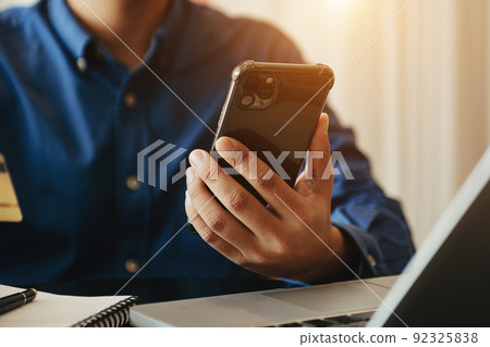 Businessman hand using smart phone laptop and tablet with social network diagram on desk as concept Businessman hand using smart phone laptop and tablet with social network diagram on desk as concept 92325838