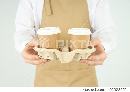 Waiter or barista holds holder with paper cups Waiter or barista holds holder with paper cups 92328951